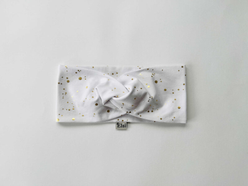 Valgel kuldsed täpid